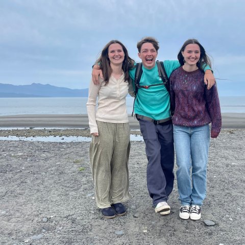 a group of people standing on a beach